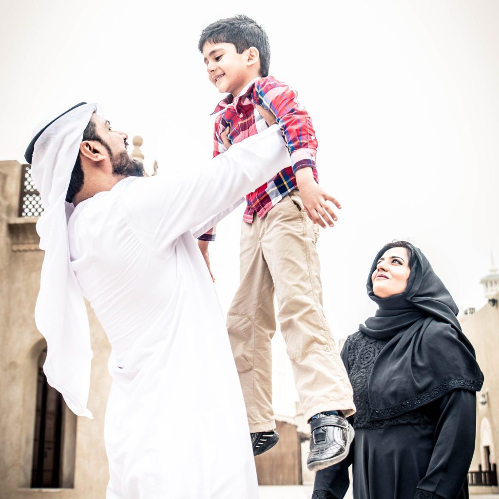 Arabic family playing with child