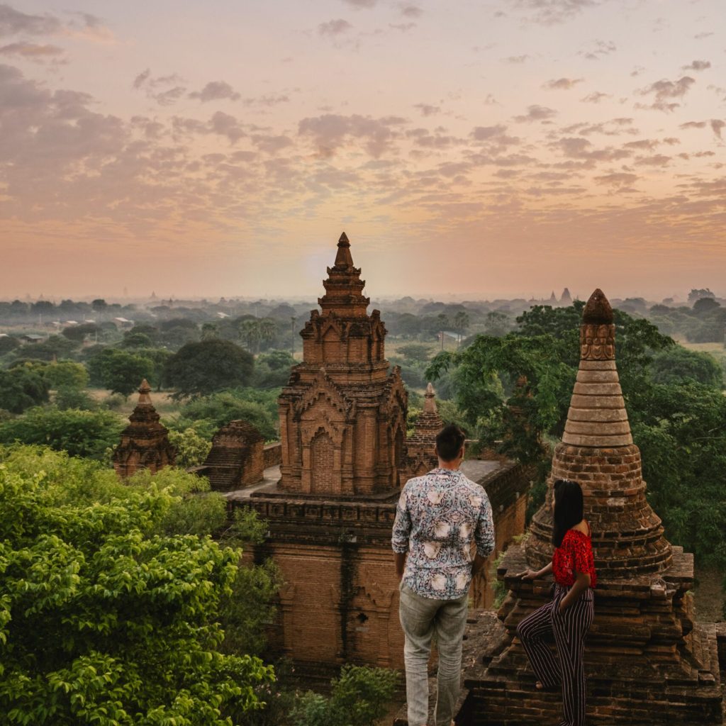 Bagan Myanmar, Sunrise above temples and pagodas of Bagan Myanmar, Sunrise Pagan Myanmar temple and pagoda. Men and woman at an old pagoda