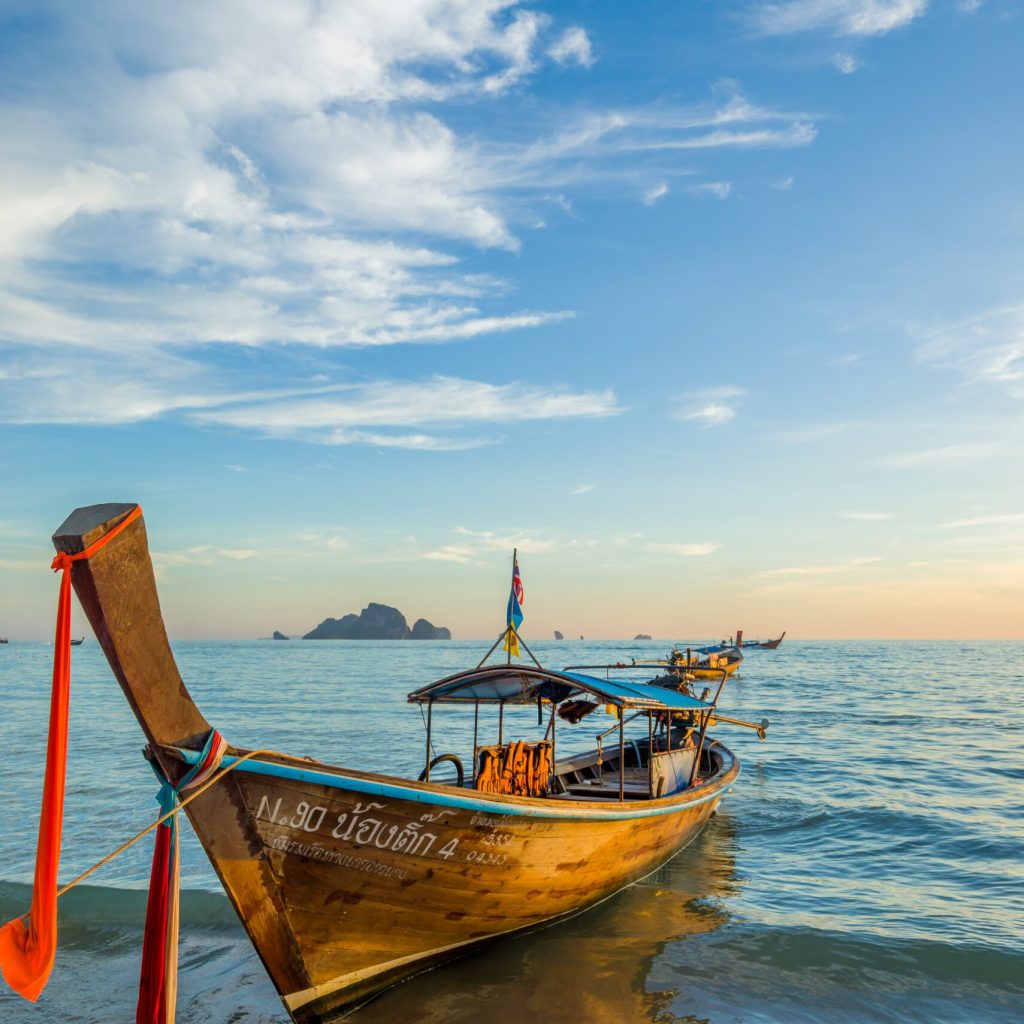 AO NANG, KRABI - FEBRUARY 24, 2017: Traditional Thai fishing Long Tail  boat on the shore of Ao Nang Krabi Thailand